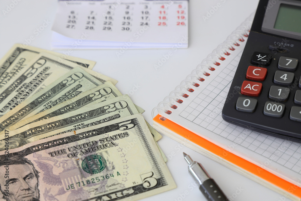 Calculator and dollars isolated on white background Calculator and dollars isolated on white background