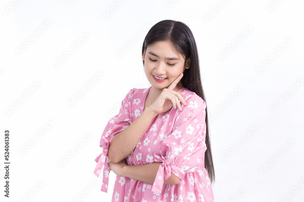 Asian beautiful girl in pink dress and black long hair. Her hands touch cheek smile, show beautiful skin on white background. Asian beautiful girl in pink dress and black long hair. Her hands touch cheek smile, show beautiful skin on white background.