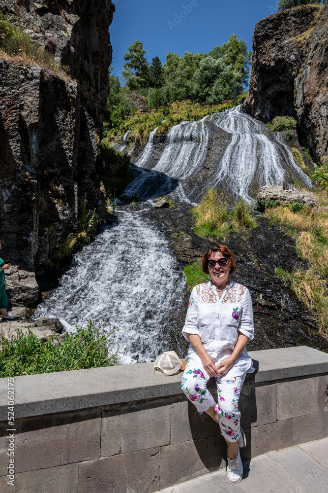 Waterfall - Hair of a Mermaid gently spreads over round stones in the mountains of Armenia
