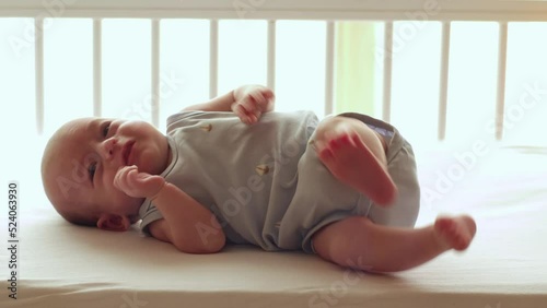 Newborn baby waking up hungry with startle reflex photo