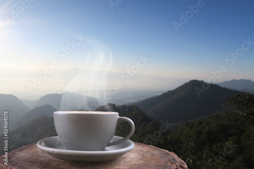 Hot coffee and smoke in gray cup with high mountain morning view in thailand