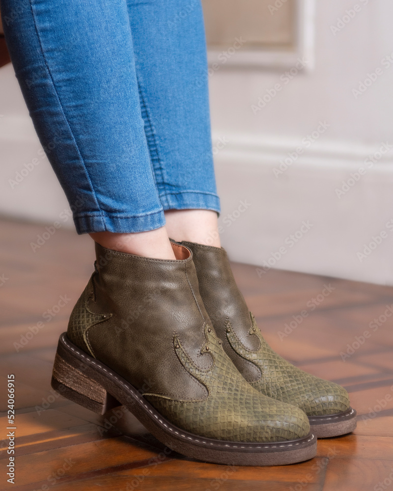 woman's legs wearing leather fashion shoes of different casual and dress styles in assorted colors woman's legs wearing leather fashion shoes of different casual and dress styles in assorted colors