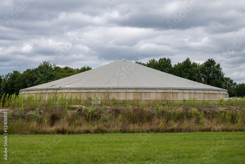 Concrete manure silo in a meadow in the north of the Netherlands. photo