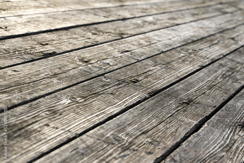 Weathered gray wooden floorboards as background photo.