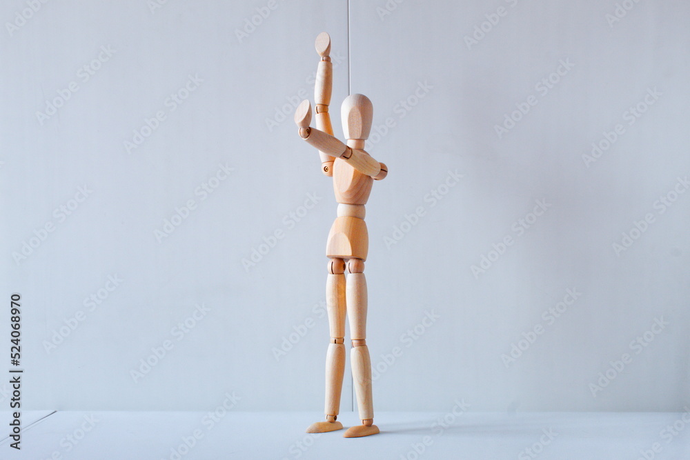 Concept of making the stop signal with the figure of a wooden boy Concept of making the stop signal with the figure of a wooden boy