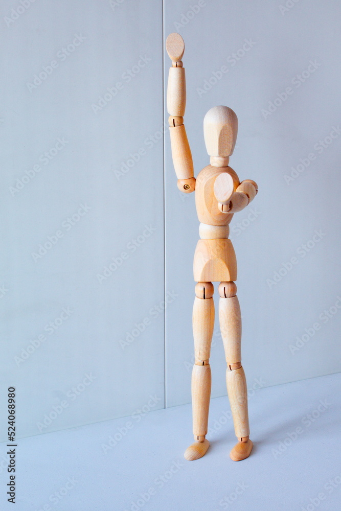 Concept of making the stop signal with the figure of a wooden boy Concept of making the stop signal with the figure of a wooden boy