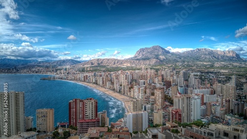 Aerial shot of the Benidorm cityscape with the seawater washing the coast photo