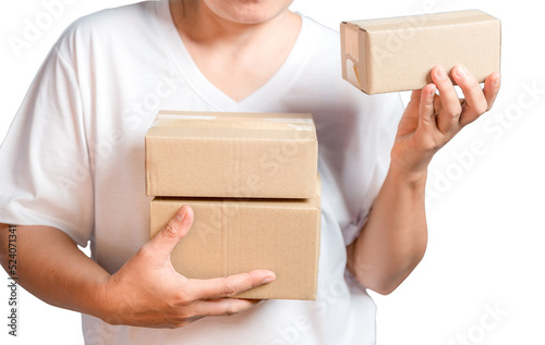 A parcel cardboard parcel box in a delivery woman person hands isolated on white background. Delivery service concept. Asian Young girl holding a package is a delivery business entrepreneur.