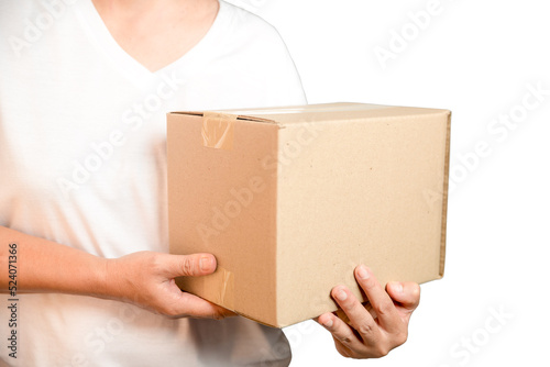 A parcel cardboard parcel box in a delivery woman person hands isolated on white background. Delivery service concept. Asian Young girl holding a package is a delivery business entrepreneur. © doidam10