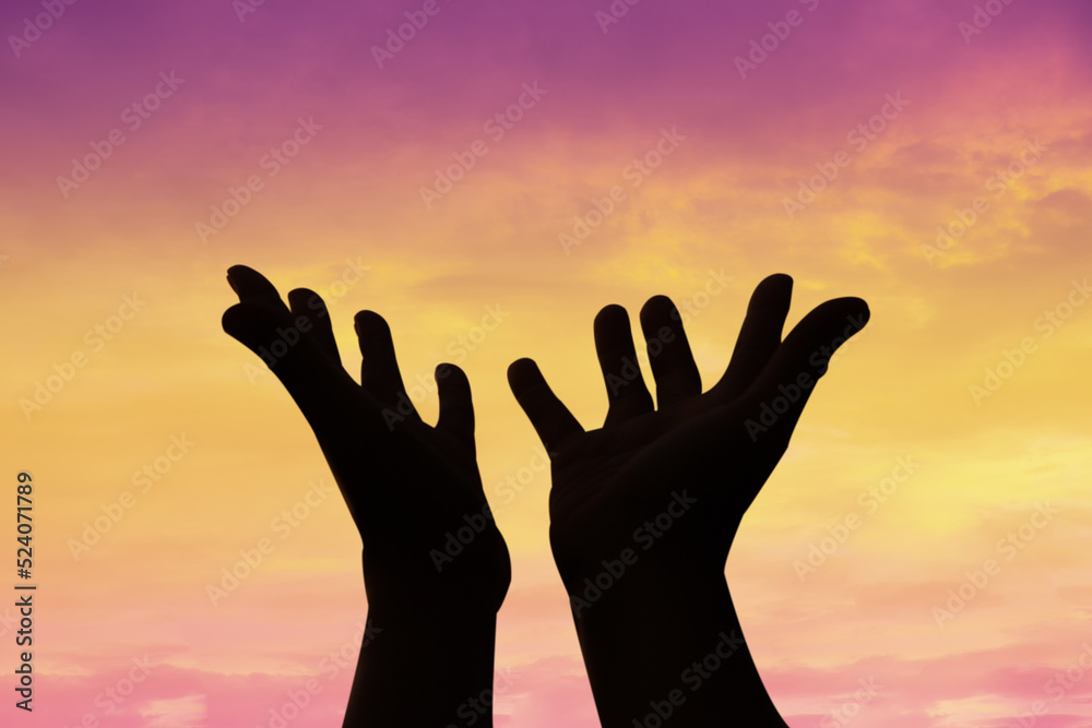 Person human hands open palm up worship or pray for god. background is sunrise. Concept for Christian, Christianity, Catholic religion, divine, heavenly, celestial or god.