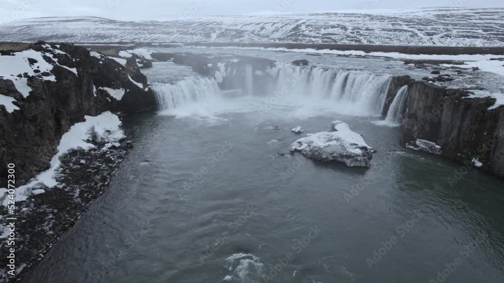 Scenic waterfall streaming from rocky cliff on winter day Scenic waterfall streaming from rocky cliff on winter day