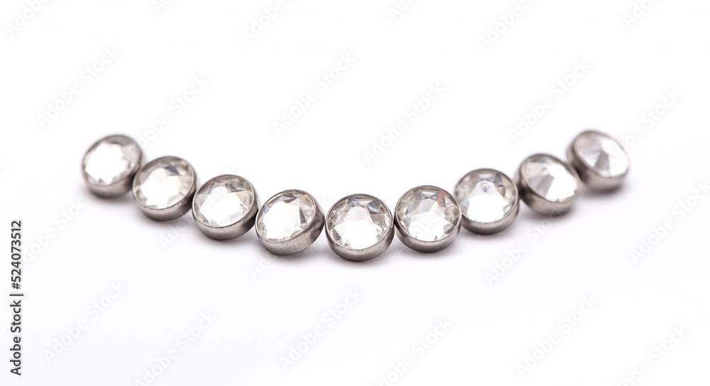 A set of jewelry for piercing on a white background. A set of earrings for the body, nose, navel, tongue, nipples, ears, various beauty jewelry, a set of cosmetological jewelry for piercing. A set of jewelry for piercing on a white background. A set of earrings for the body, nose, navel, tongue, nipples, ears, various beauty jewelry, a set of cosmetological jewelry for piercing.