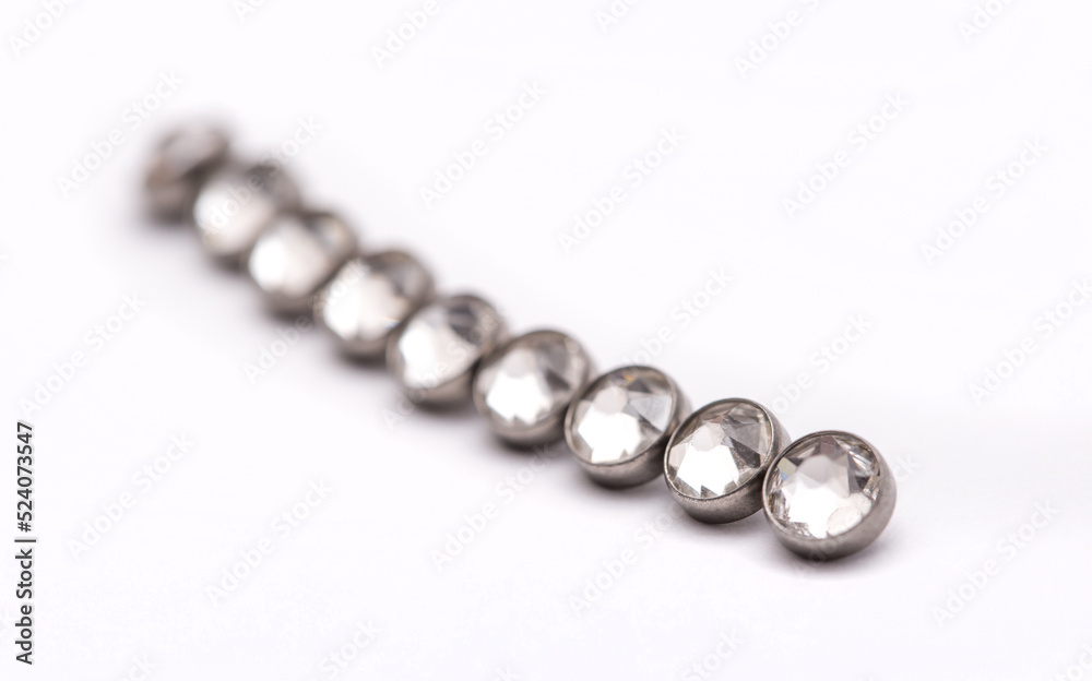 A set of jewelry for piercing on a white background. A set of earrings for the body, nose, navel, tongue, nipples, ears, various beauty jewelry, a set of cosmetological jewelry for piercing. A set of jewelry for piercing on a white background. A set of earrings for the body, nose, navel, tongue, nipples, ears, various beauty jewelry, a set of cosmetological jewelry for piercing.