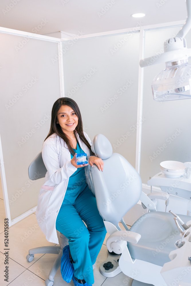 Smiling ethnic female dentist looking at camera in clinic Smiling ethnic female dentist looking at camera in clinic