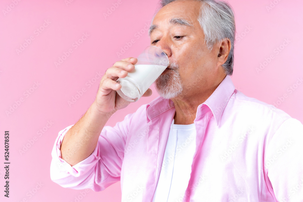 Portrait charming retired asian senior man drinking glasses of milk