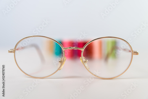 close-up of red scissors, threads behind, dressmaker, atelier, seamstress, sewing clothes, embroidering fabric, needle and thread, selective focus