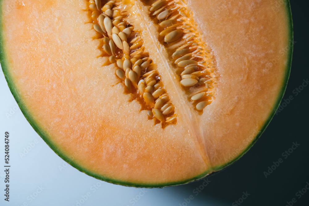 Close up shot of Cross section half cut of the Hokkaido Melon with shadow background Close up shot of Cross section half cut of the Hokkaido Melon with shadow background