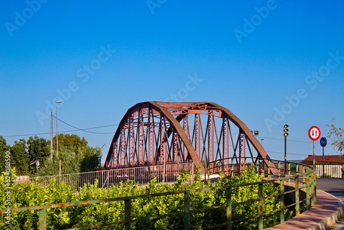 Nice landscape with an old metal bridge that crosses over the Segura River that carries water to irrigate the garden of Murcia © JuanPablo
