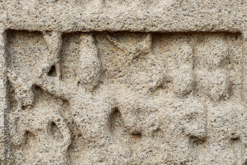 Bas relief rock cut sculptures of gods, people and animals are carved prominently in the monolithic cave temples at Mahabalipuram, Tamil nadu, India photo