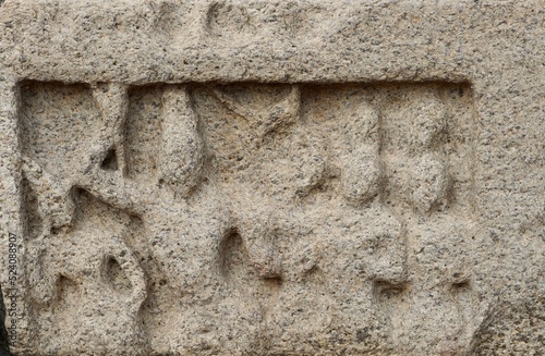 Bas relief rock cut sculptures of gods, people and animals are carved prominently in the monolithic cave temples at Mahabalipuram, Tamil nadu, India photo
