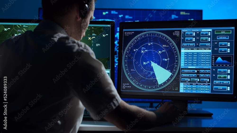 Workplace of the professional air traffic controller in the control tower. Caucasian aircraft control officer works using radar, computer navigation and digital maps. Aviation concept. Workplace of the professional air traffic controller in the control tower. Caucasian aircraft control officer works using radar, computer navigation and digital maps. Aviation concept.