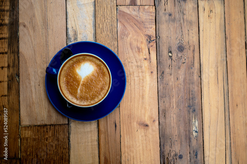 A milk coffee on a wood table