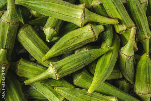 Fresh raw okra in a glass bowl. Healthy eating concept photo