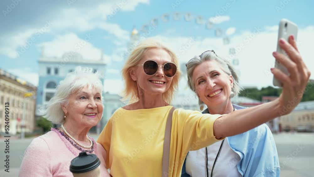 Senior women making shopping in the city center and having fun speaking about gossip and funny things. Concept about seniority and lifestyle Senior women making shopping in the city center and having fun speaking about gossip and funny things. Concept about seniority and lifestyle