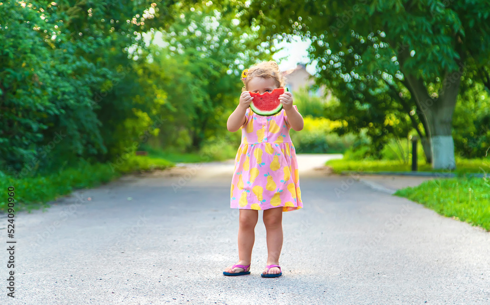 Child girl eats watermelon in summer. Selective focus. Child girl eats watermelon in summer. Selective focus.