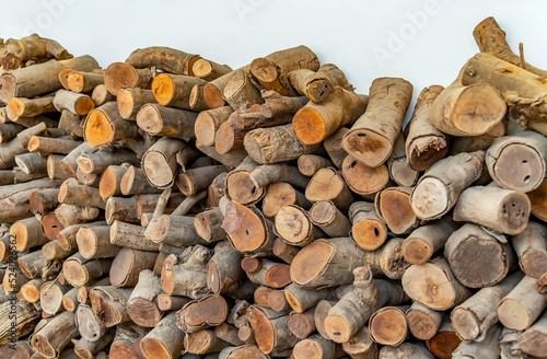 Stack of wood logs. Preparation of firewood for the winter.