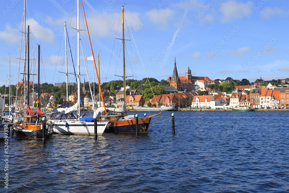 The historical port of Flensburg and the St. Marys church and the old town in background, Germany