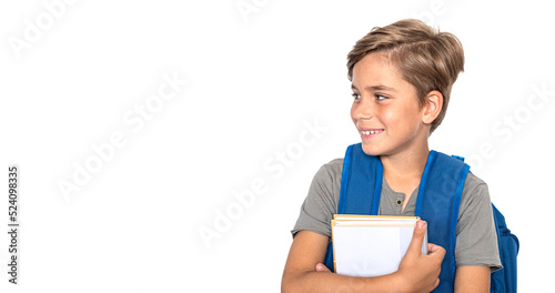 Smiling boy looks at the side with books and backpack isolated on white background