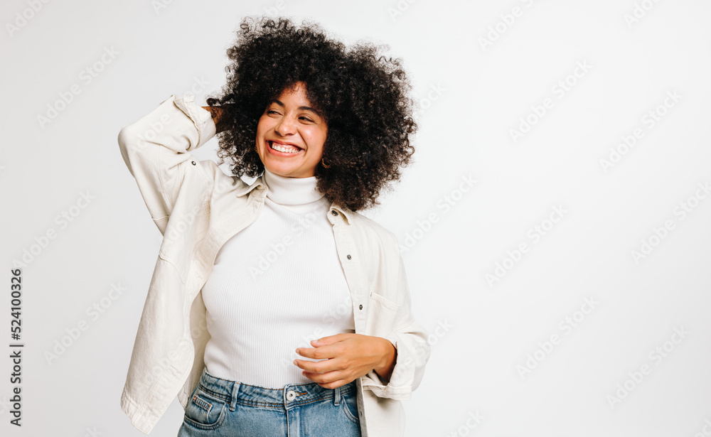 Beautiful woman with Afro hair smiling happily in a studio Beautiful woman with Afro hair smiling happily in a studio