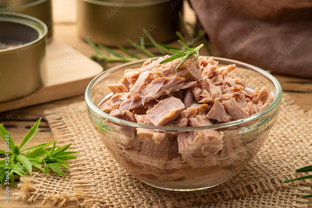 Close up Canned tuna in brine in glass bowl on wooden table Close up Canned tuna in brine in glass bowl on wooden table