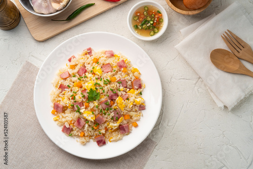 Thai Fried rice with egg and sliced ham carrot in white plate.Easy cooking food.Top view
