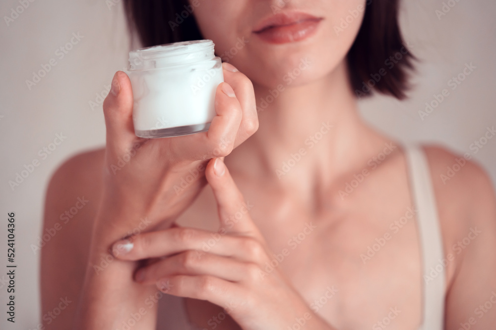 Girl applies a moisturizing cream on her face. Girl applies a moisturizing cream on her face.