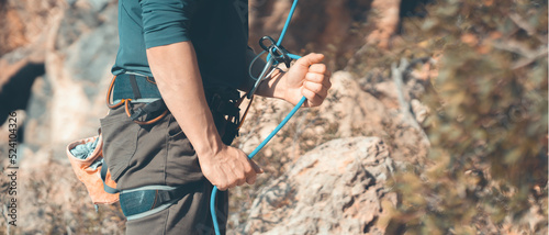 Man is engaged in extreme sports, rock climbing.