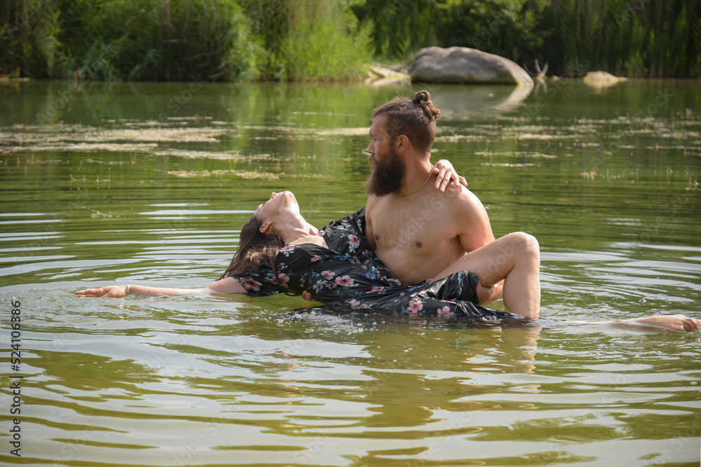 Fototapeta premium caucasian couple in love having a bath in a lake