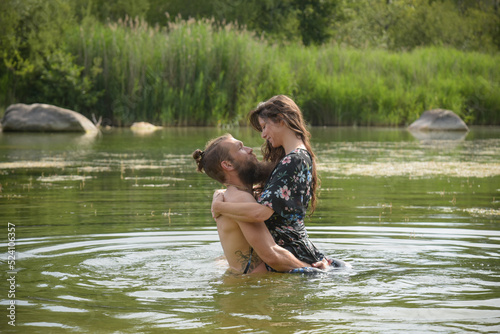 Fototapeta Naklejka Na Ścianę i Meble -  caucasian couple in love having a bath in a lake