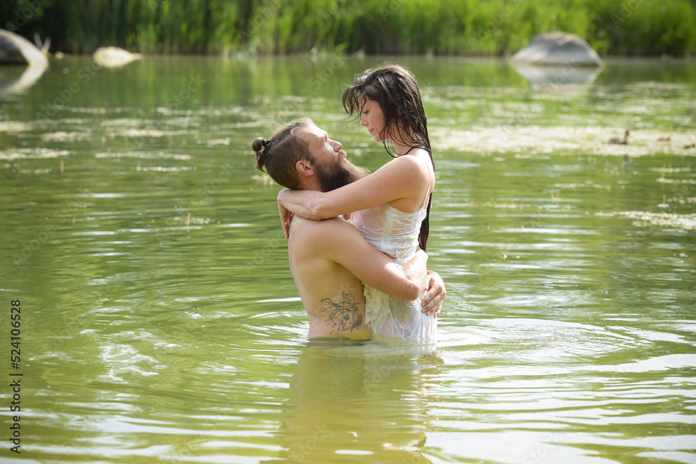 Fototapeta premium caucasian couple in love having a bath in a lake