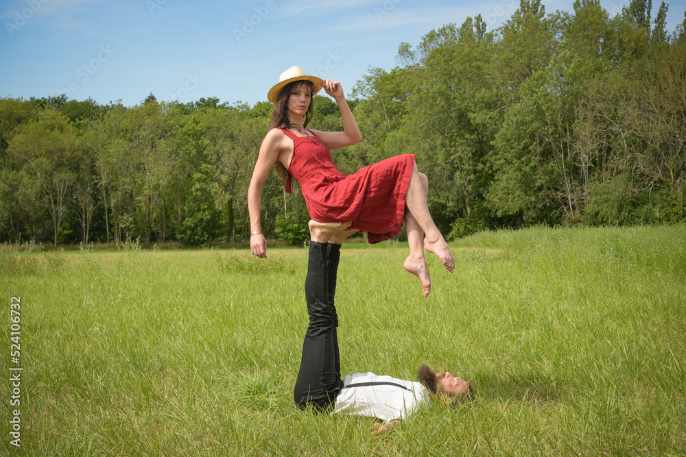 caucasian couple doing stunts on a meadow caucasian couple doing stunts on a meadow