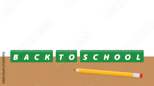 机の上に置かれたBACK TO SCHOOL の文字が入った緑色のブロック - 学校の言葉の素材
