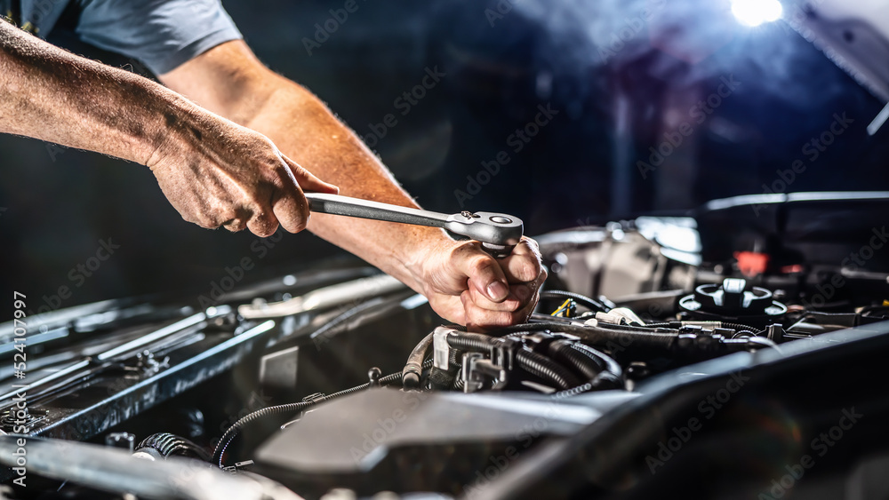 Auto mechanic working in garage. Repair service.