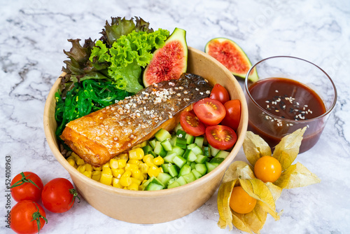 KOREAN BAKED SALMON with salad  tomato and sauce served in a bowl isolated on grey background side view healthy korean food