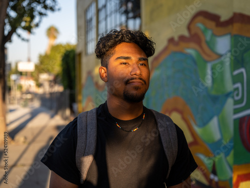 Artistic image of a Native boy student in front of school with shadows on his face