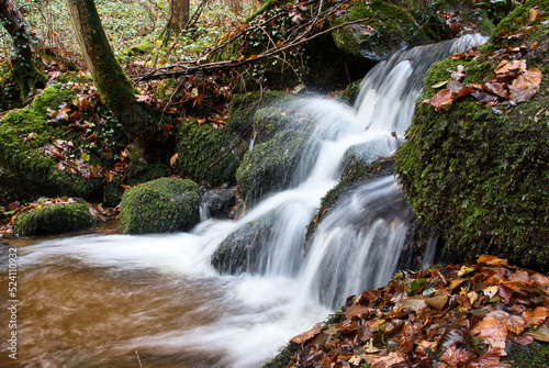 Waterfall at Gaisholl waterfalls in the Black forest of Germany on a fall day. photo