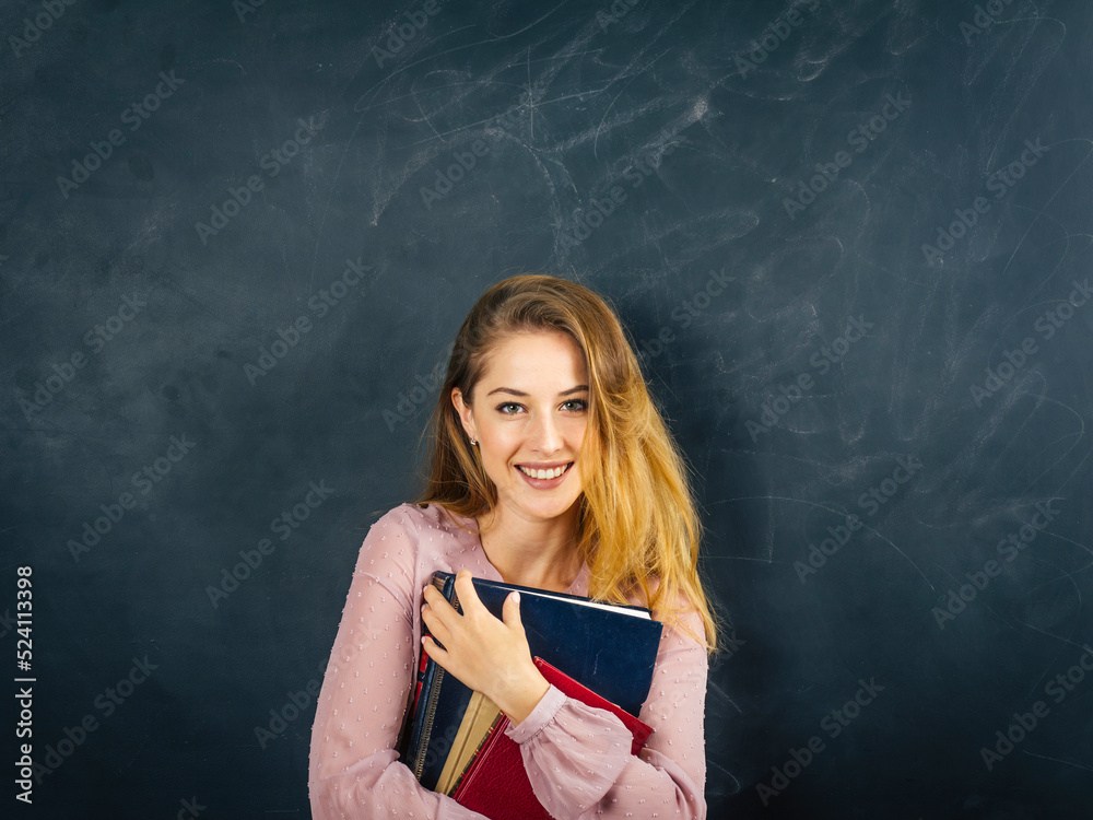 Beautiful young student in front of blackboard Beautiful young student in front of blackboard