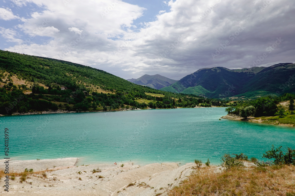 Panorama of the Fiastra Lake on the Sibillini Mountains in Marche. Italy. Dark clouds ae coming.