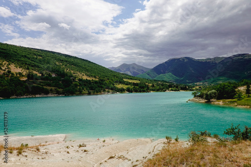 Panorama of the Fiastra Lake on the Sibillini Mountains in Marche. Italy. Dark clouds ae coming.