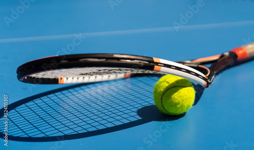 a broken tennis racket blue tennis court. © Angelov